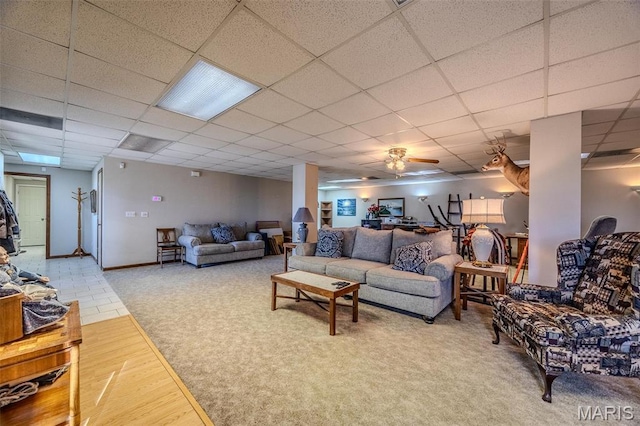 23598 Falcon Rd, Lebanon, MO 65536 - living room featuring wood finished floors, a paneled ceiling, a ceiling fan, and baseboards