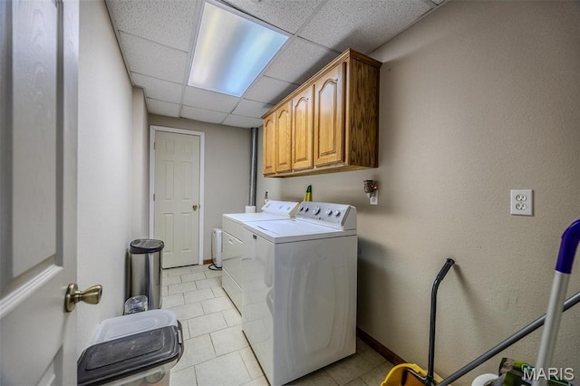 23598 Falcon Rd, Lebanon, MO 65536 - clothes washing area with cabinet space, washing machine and clothes dryer, light tile patterned floors, and baseboards