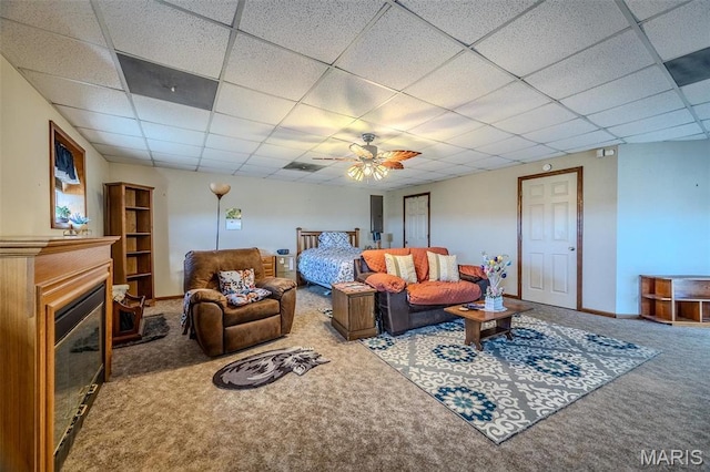 23598 Falcon Rd, Lebanon, MO 65536 - living room with carpet floors, a paneled ceiling, ceiling fan, a glass covered fireplace, and baseboards