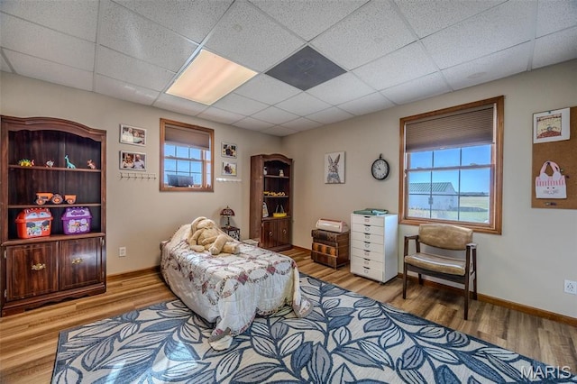 23598 Falcon Rd, Lebanon, MO 65536 - living area featuring wood finished floors, a paneled ceiling, and baseboards
