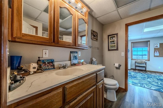 23598 Falcon Rd, Lebanon, MO 65536 - bathroom with a drop ceiling, wood finished floors, toilet, baseboards, and vanity