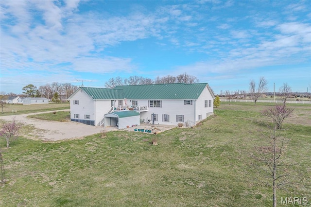 23598 Falcon Rd, Lebanon, MO 65536 - rear view of property featuring a lawn, metal roof, and driveway