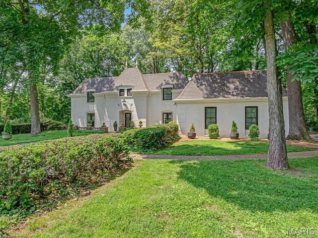 335 N Powder Mill Rd, Belleville, IL 62223 - french country style house featuring a front lawn and a shingled roof