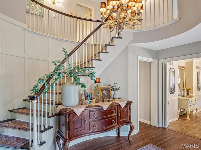 335 N Powder Mill Rd, Belleville, IL 62223 - stairway featuring wood finished floors, a chandelier, and a high ceiling