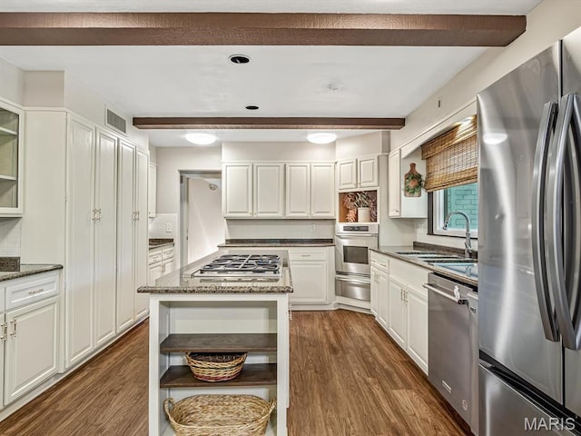 335 N Powder Mill Rd, Belleville, IL 62223 - kitchen with stainless steel appliances, beam ceiling, dark wood-type flooring, dark stone countertops, and white cabinets