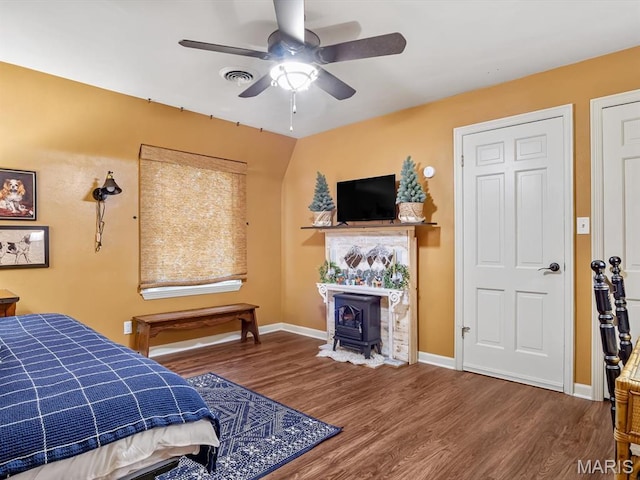 335 N Powder Mill Rd, Belleville, IL 62223 - bedroom featuring wood finished floors, a wood stove, and ceiling fan
