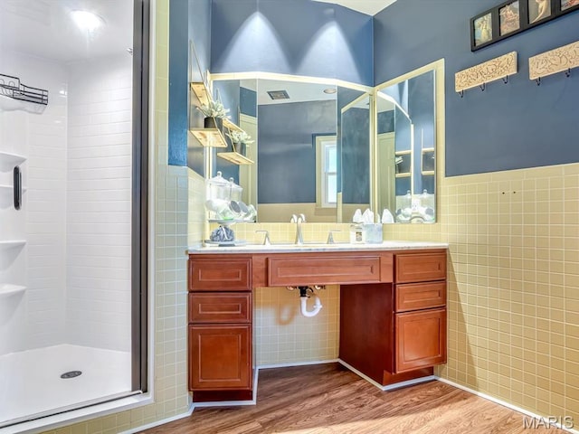 335 N Powder Mill Rd, Belleville, IL 62223 - full bath with tile walls, wood finished floors, a stall shower, vanity, and a wainscoted wall