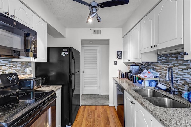 1511 Hampton Hall Dr Unit 22, Chesterfield, MO 63017 - kitchen with black appliances, a sink, ceiling fan, light wood finished floors, and white cabinets