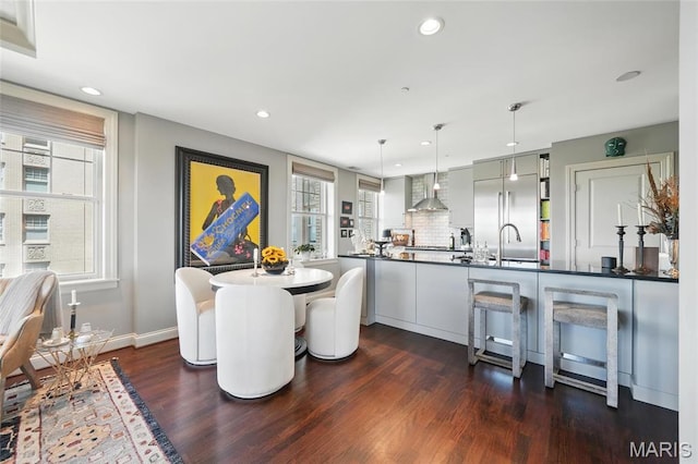 dining space with dark wood-style floors, recessed lighting, and baseboards