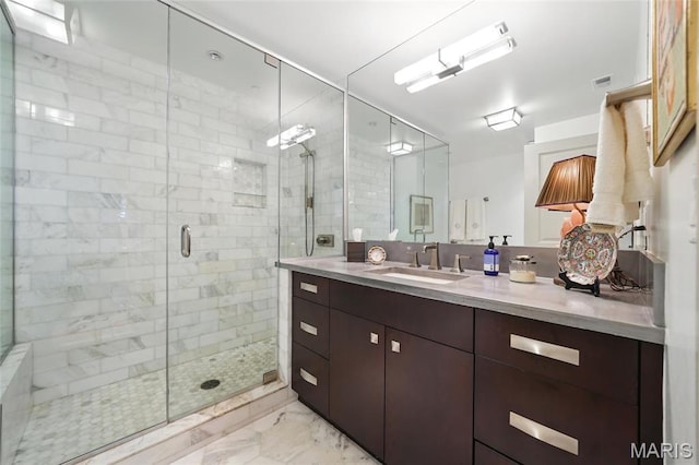 bathroom featuring marble finish flooring, a stall shower, and vanity