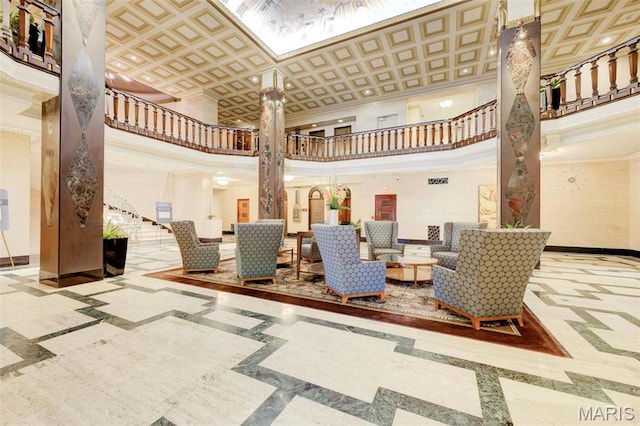 building lobby with crown molding, stairs, and a towering ceiling