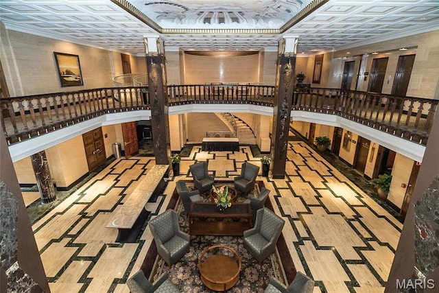 community lobby featuring an ornate ceiling and stairs
