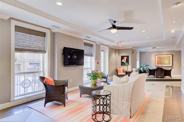 living room featuring a raised ceiling, baseboards, ceiling fan, recessed lighting, and ornamental molding