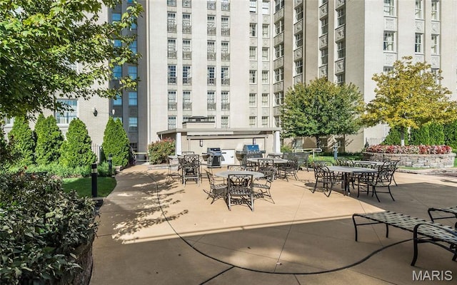 surrounding community featuring outdoor dining space