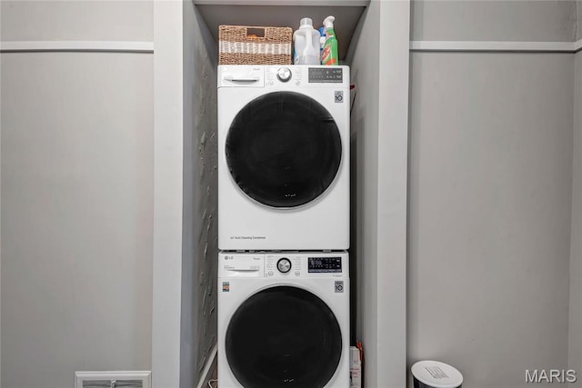 clothes washing area featuring estacked washer and dryer