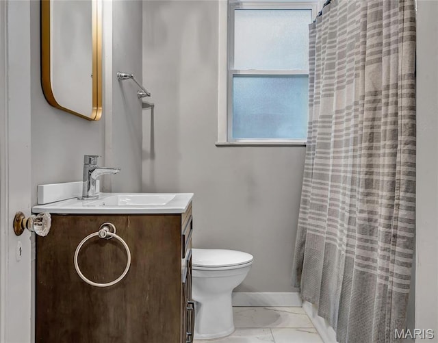 bathroom with toilet, marble finish floors, vanity, and a shower with curtain