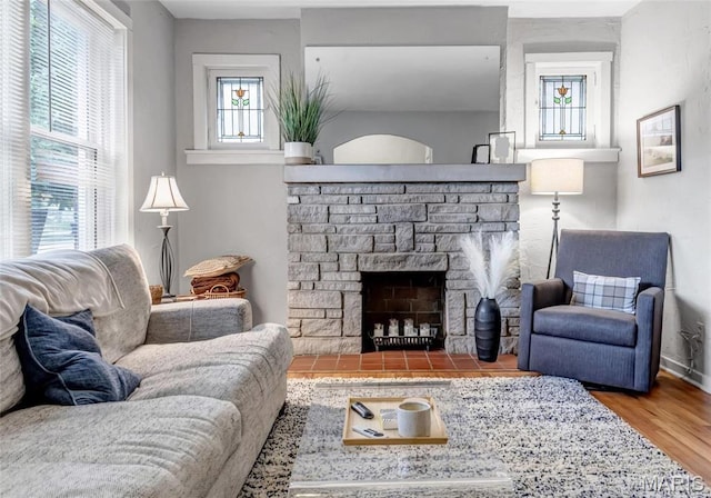 living room with wood finished floors and a fireplace