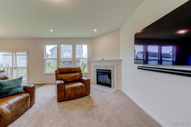 living room featuring carpet flooring, a premium fireplace, plenty of natural light, recessed lighting, and baseboards