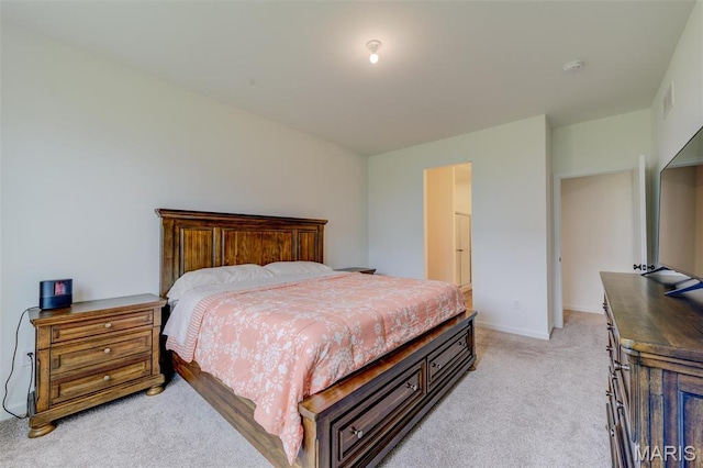 bedroom featuring light carpet and baseboards