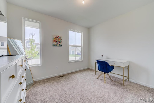office area with light carpet and baseboards