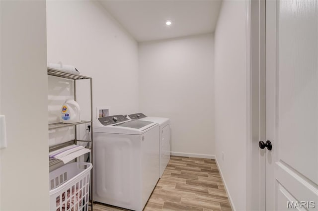 washroom with separate washer and dryer, light wood-style floors, recessed lighting, and baseboards