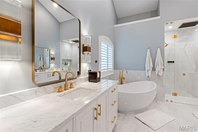 full bath with a shower stall, tile walls, a freestanding bath, vanity, and a towering ceiling