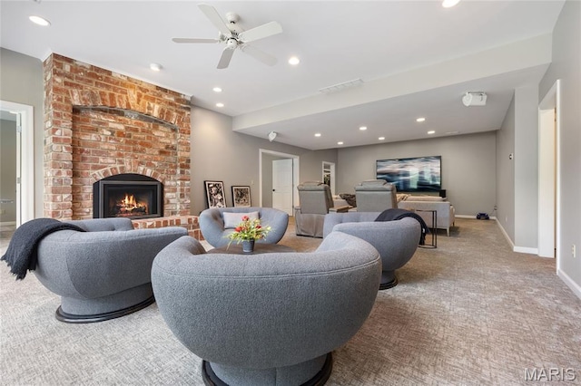 carpeted living area with recessed lighting, a ceiling fan, a fireplace, and baseboards