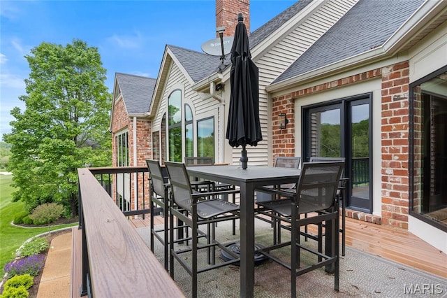 wooden deck with outdoor dining space