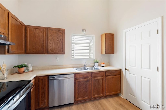 8704 Garden Ct, Brentwood, MO 63144 - kitchen featuring appliances with stainless steel finishes, brown cabinets, light wood-type flooring, and light countertops