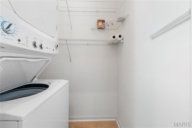 8704 Garden Ct, Brentwood, MO 63144 - laundry room featuring stacked washer and clothes dryer and light wood-style floors