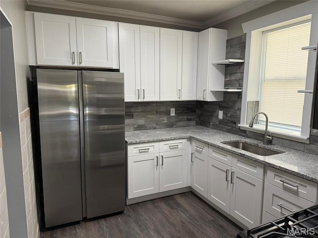 139 Euclid Ave, Saint Louis, MO 63119 - kitchen with freestanding refrigerator, a sink, open shelves, white cabinetry, and light stone counters