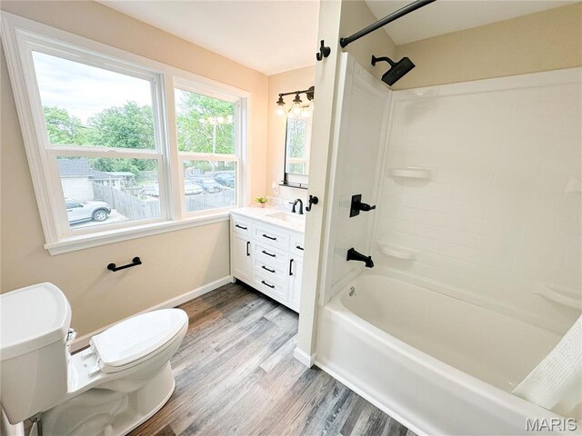 800 E Center St, Salem, MO 65560 - full bathroom featuring toilet, wood finished floors, vanity, bathtub / shower combination, and baseboards