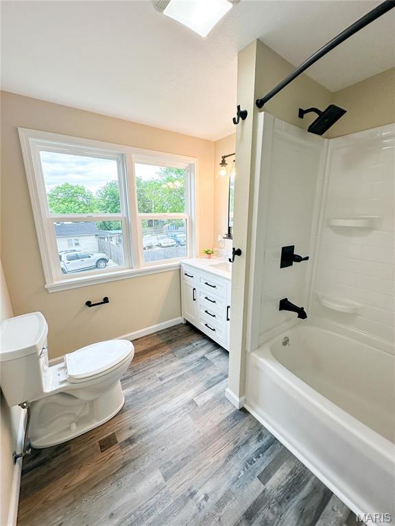 800 E Center St, Salem, MO 65560 - full bath with toilet, wood finished floors, shower / tub combination, vanity, and baseboards