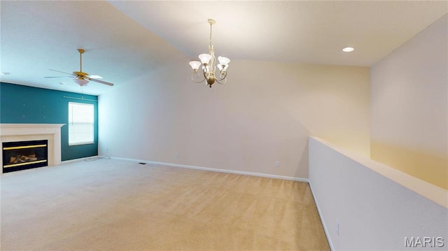 unfurnished living room with a ceiling fan, light colored carpet, lofted ceiling, a glass covered fireplace, and baseboards