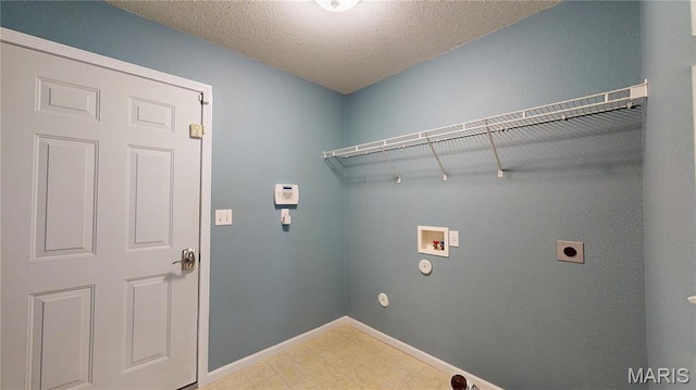 laundry room with hookup for a washing machine, hookup for an electric dryer, tile patterned floors, baseboards, and a textured ceiling