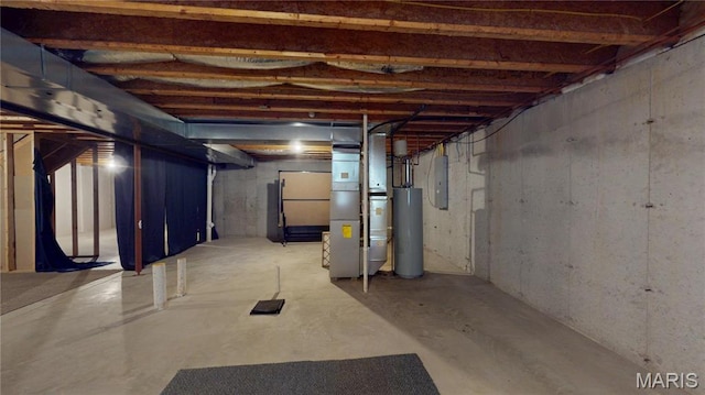 unfinished below grade area featuring gas water heater, electric panel, and heating unit