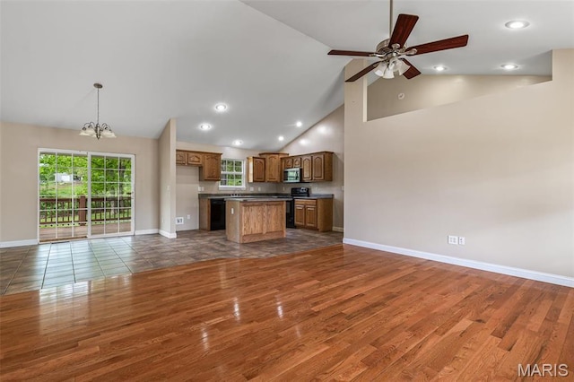 1824 Oak Knl, Farmington, MO 63640 - unfurnished living room featuring wood finished floors, a chandelier, high vaulted ceiling, baseboards, and ceiling fan