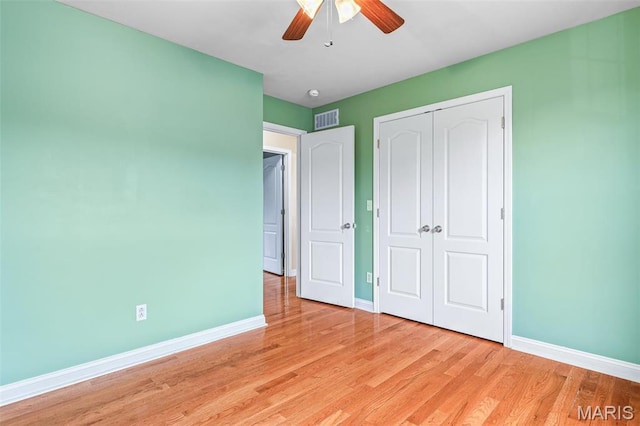 1824 Oak Knl, Farmington, MO 63640 - unfurnished bedroom with baseboards, a closet, light wood-type flooring, and a ceiling fan