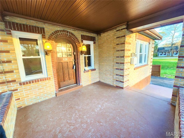 436 Hern Ave, Saint Louis, MO 63135 - view of exterior entry with brick siding and a porch