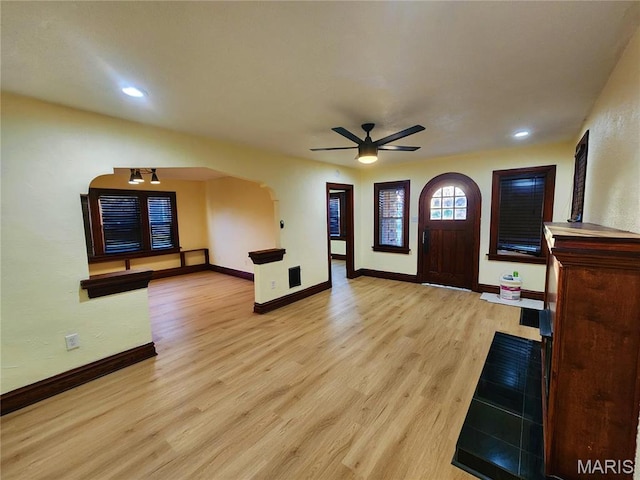 436 Hern Ave, Saint Louis, MO 63135 - foyer entrance featuring ceiling fan, baseboards, light wood finished floors, arched walkways, and recessed lighting