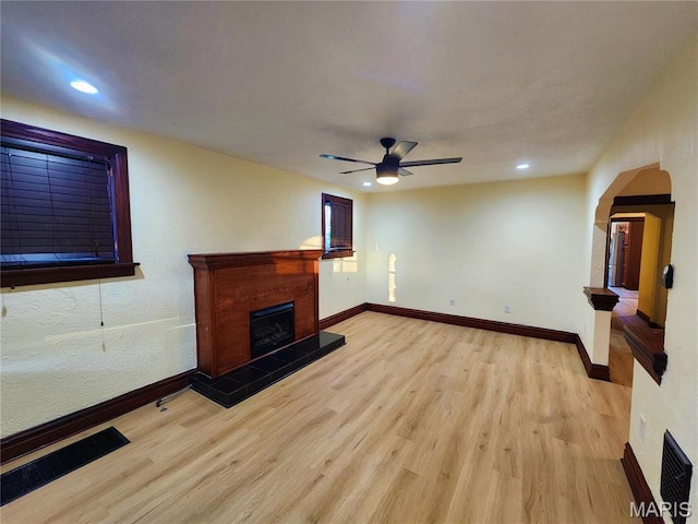 436 Hern Ave, Saint Louis, MO 63135 - unfurnished living room with a tiled fireplace, light wood-style flooring, ceiling fan, recessed lighting, and baseboards