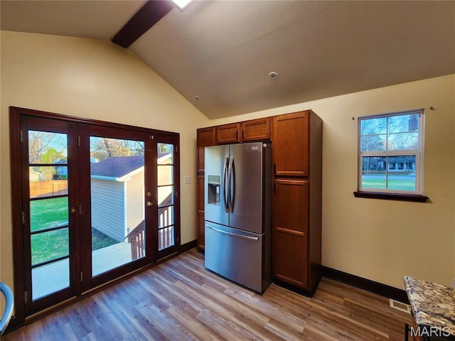 436 Hern Ave, Saint Louis, MO 63135 - kitchen featuring stainless steel fridge with ice dispenser, french doors, light wood finished floors, baseboards, and brown cabinetry