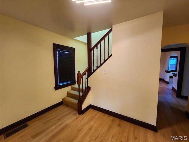 436 Hern Ave, Saint Louis, MO 63135 - stairway featuring wood finished floors, baseboards, and arched walkways