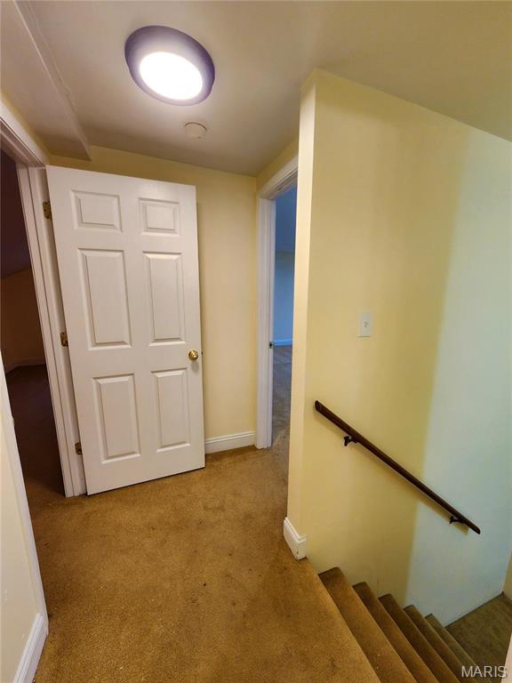 436 Hern Ave, Saint Louis, MO 63135 - hallway with carpet, an upstairs landing, and baseboards