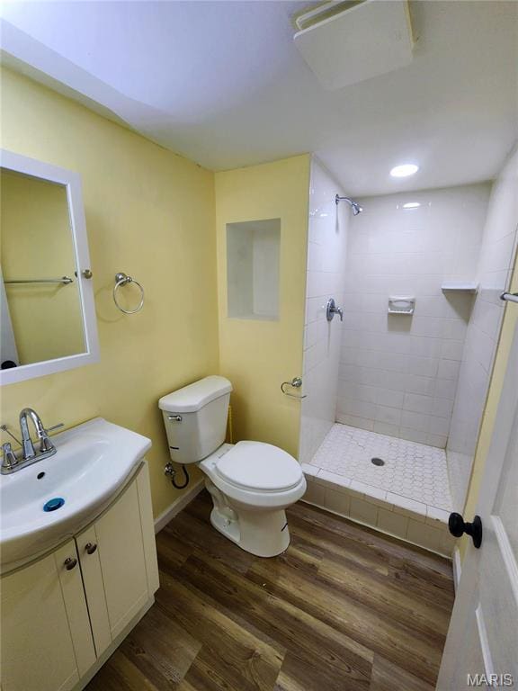 436 Hern Ave, Saint Louis, MO 63135 - full bath with toilet, a tile shower, wood finished floors, and vanity