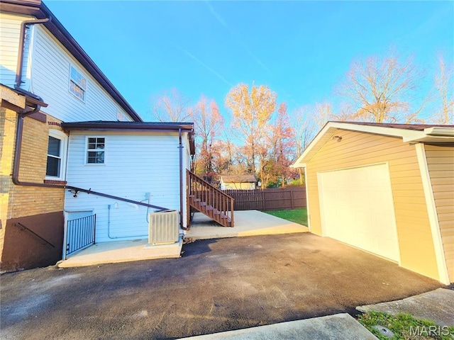 436 Hern Ave, Saint Louis, MO 63135 - view of property exterior featuring cooling unit, fence, stairs, an outbuilding, and driveway