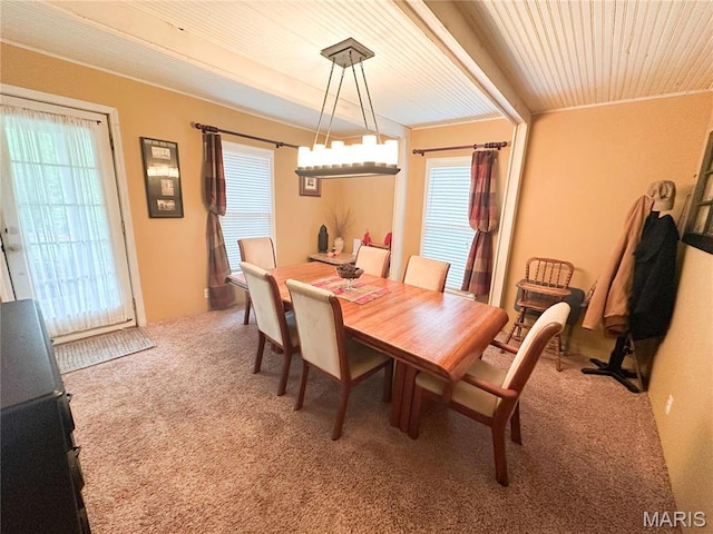dining space with carpet flooring and wooden ceiling