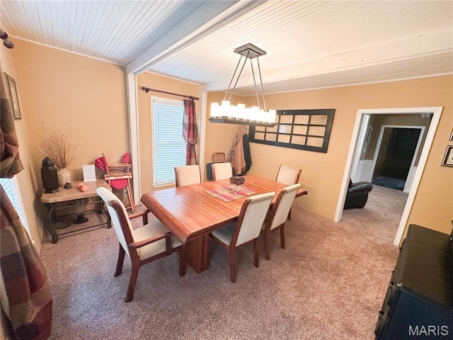 dining space with light carpet, crown molding, and a chandelier