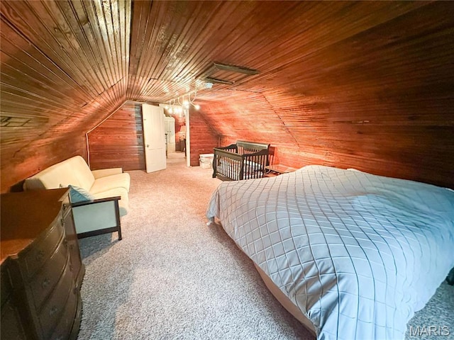 bedroom with wooden ceiling, carpet flooring, wood walls, and lofted ceiling