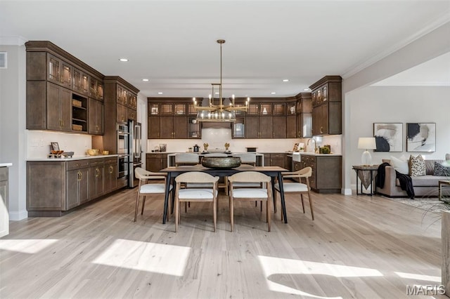 973 Tara Ct, Chesterfield, MO 63005 - dining space with light wood-style floors, ornamental molding, a chandelier, and recessed lighting